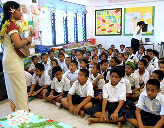 Teaching Student in front of elementary class