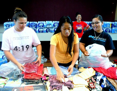 Students sort through donated clothing.